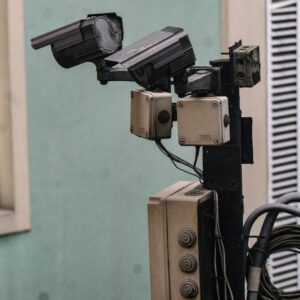Close-up of CCTV cameras mounted on a pole for urban security monitoring.