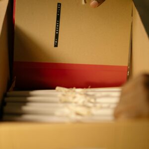 Inspecting a top-secret file within a secure, organized box of documents.